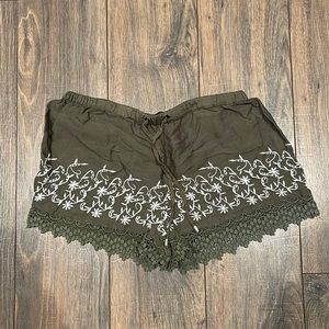 Womens green shorts with lace trim and white design